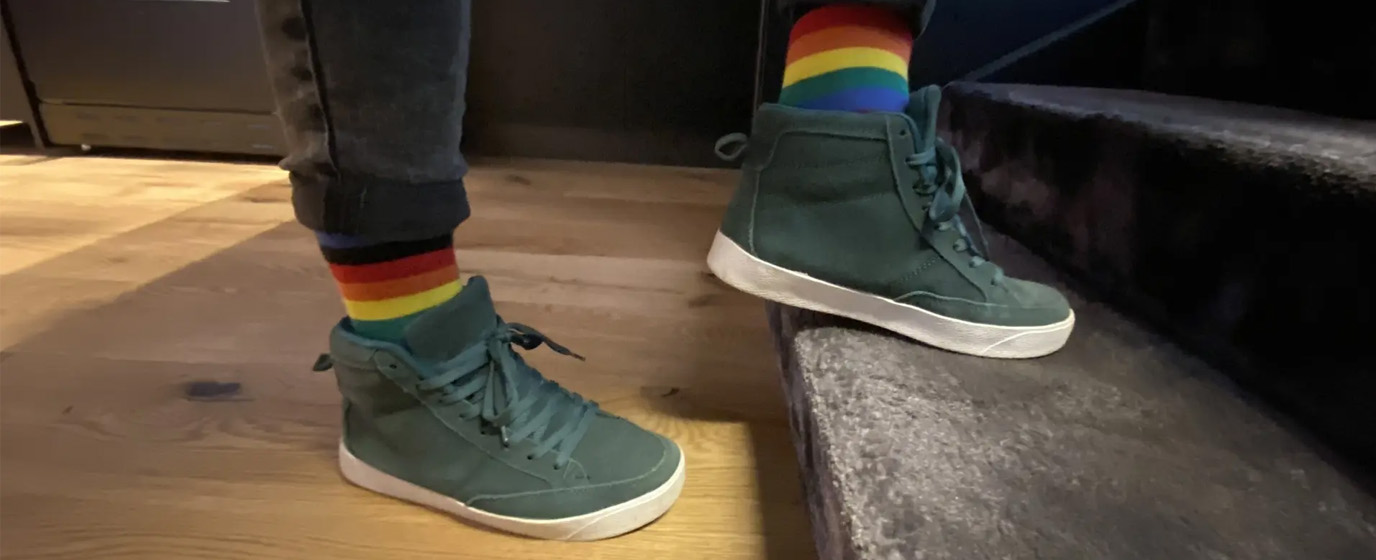 Closeup photo of persons feet in sneakers and colorful socks climbing stairs