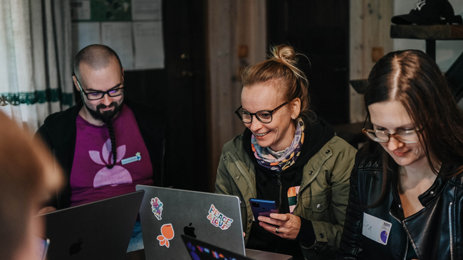 People sitting around the table and working on laptops