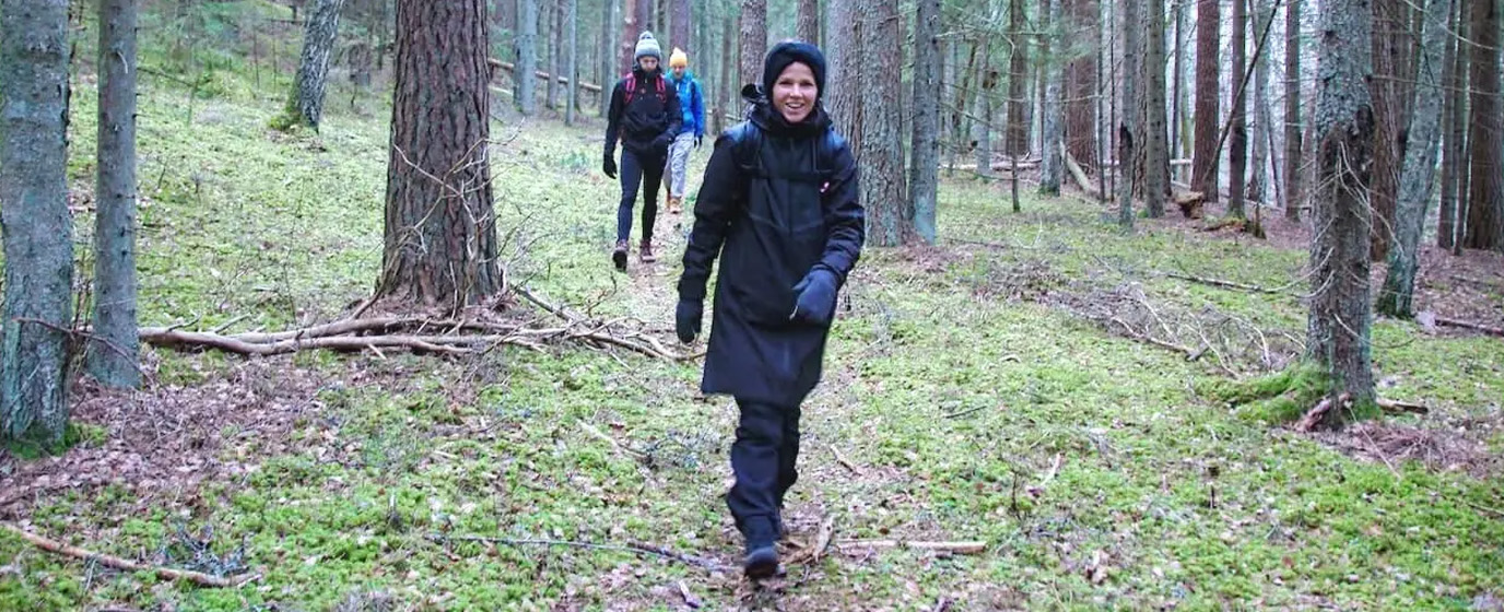 Mearra people hiking in a forest