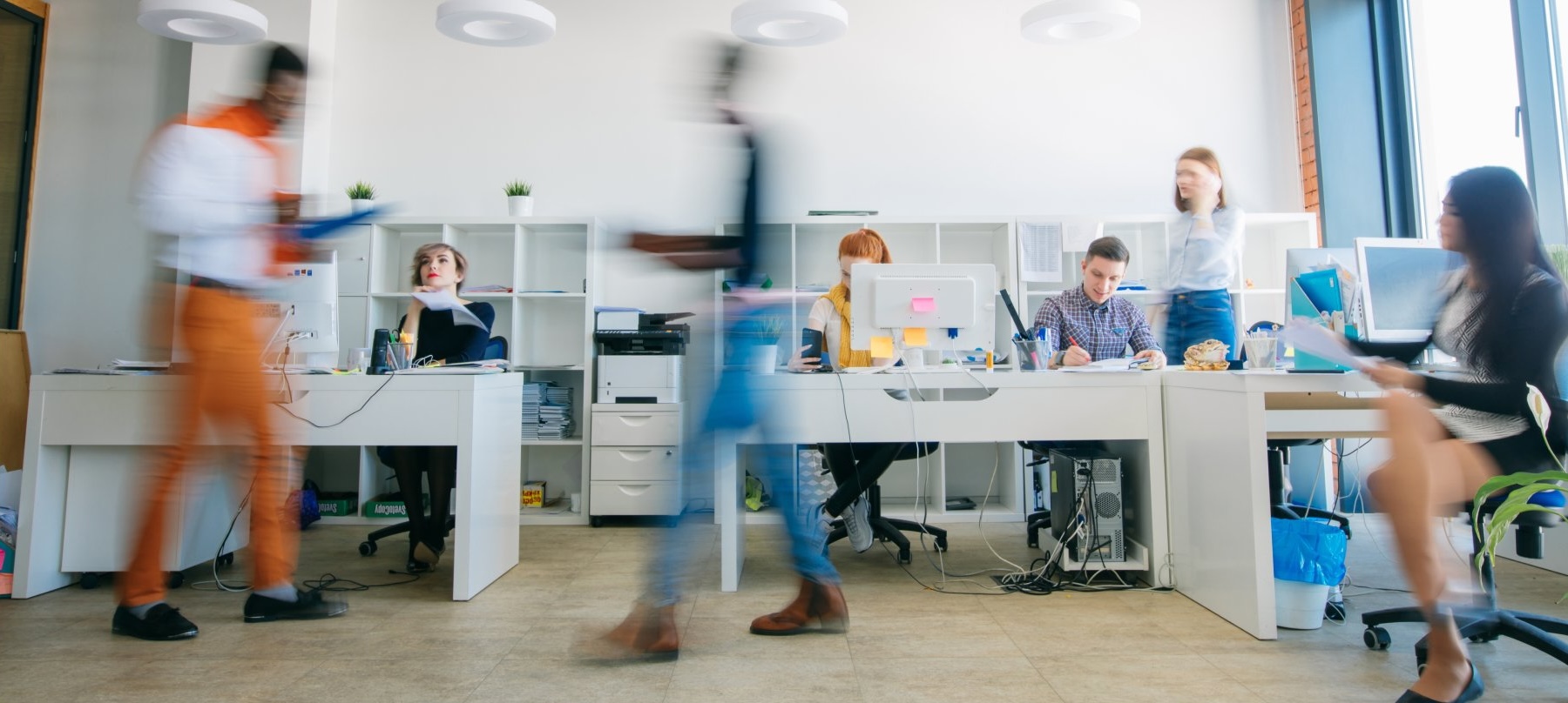 Two ladies walking and laughing in a hall