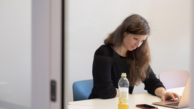 Woman sitting at the table and working.