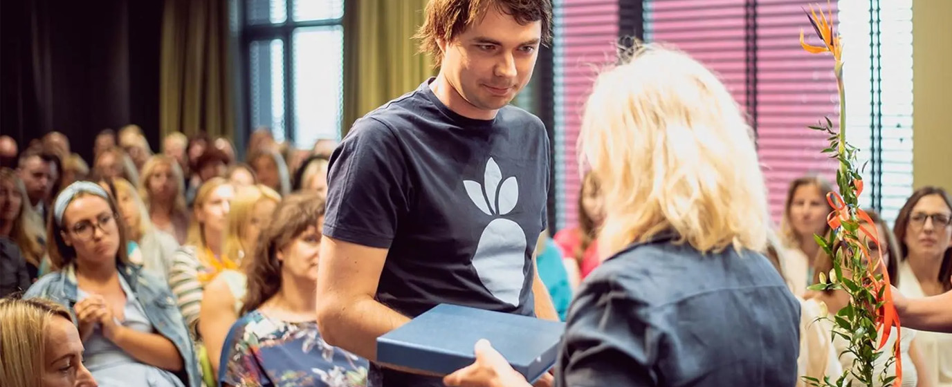 Mearra Latvia's country manager Ernests Gabrans receiving "Family friendly workplace" certificate.