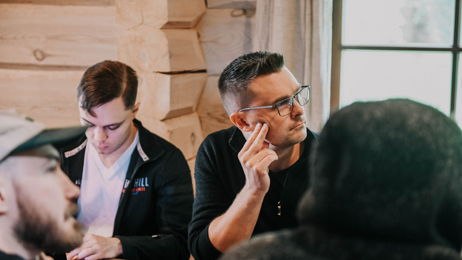 People sitting around the table and watching