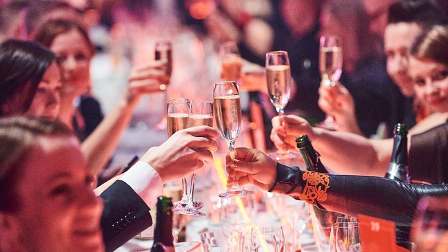 Happy people around table in the Great Place to work -gala