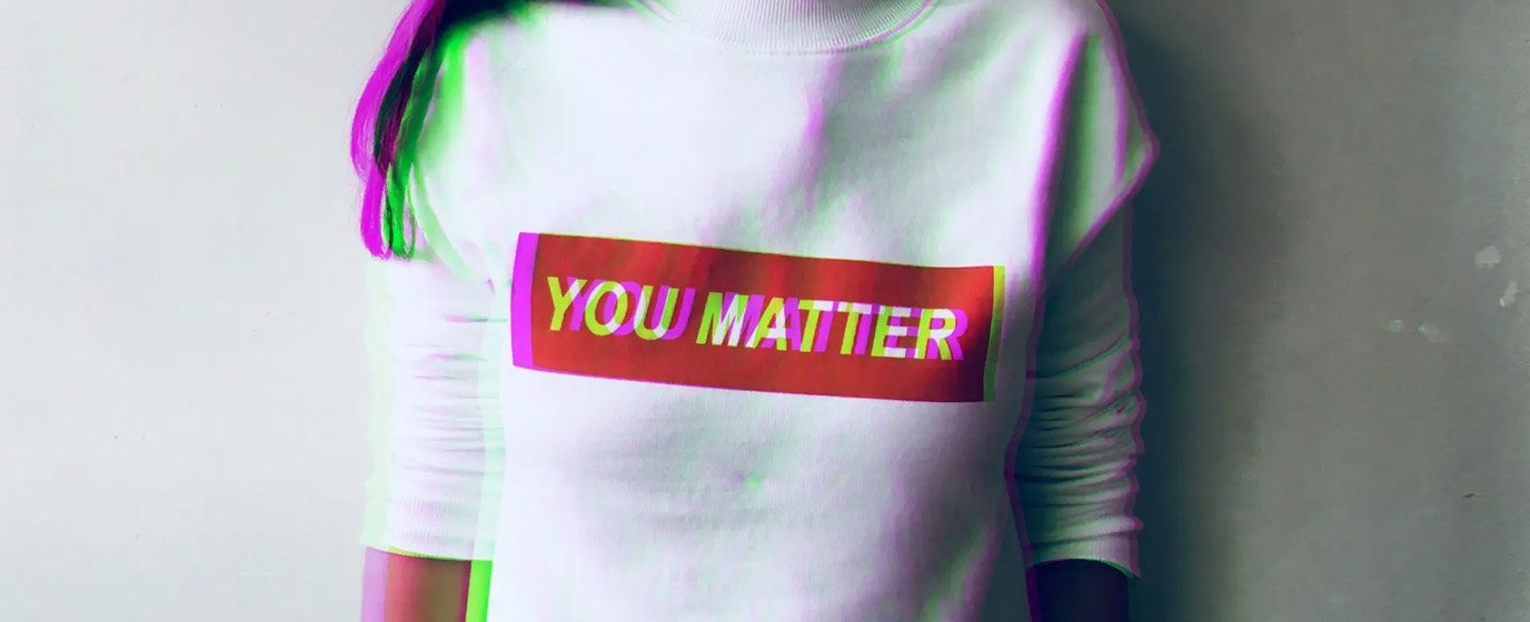 A person wearing a white t-shirt with text - You matter