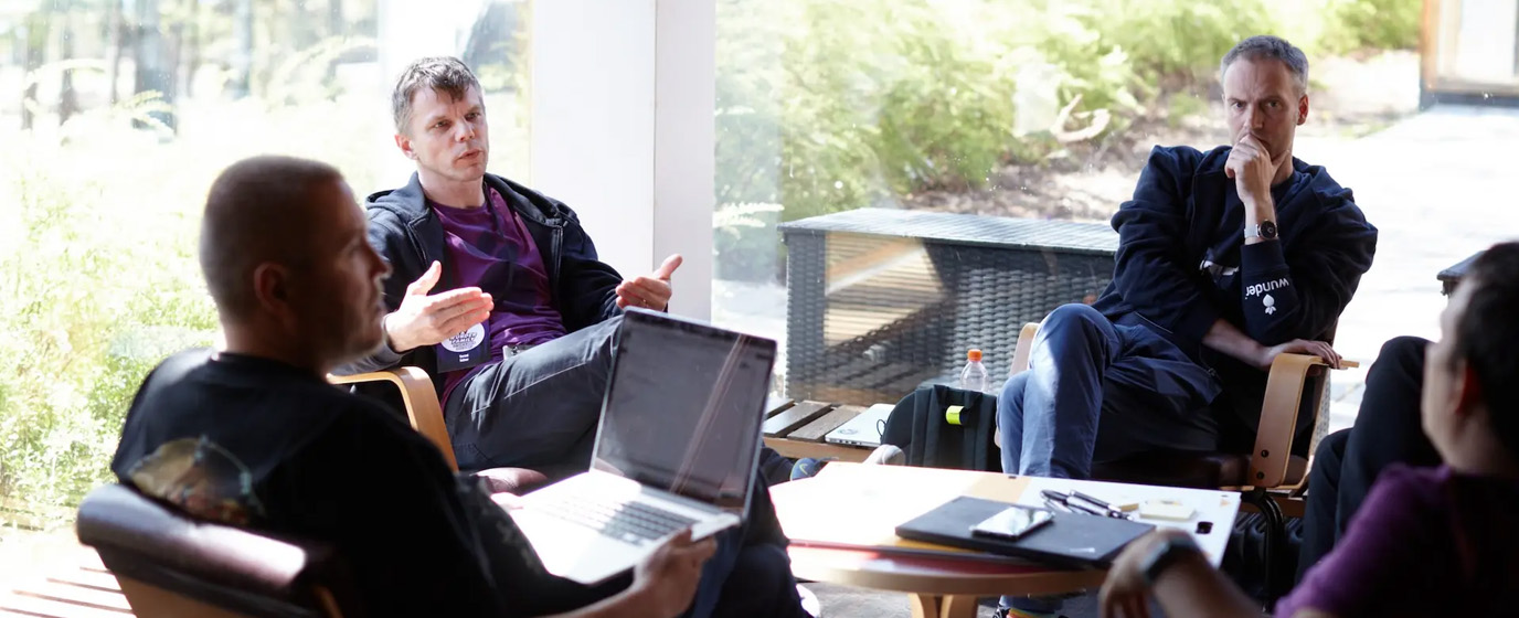 group of people sitting in a circle and discussing