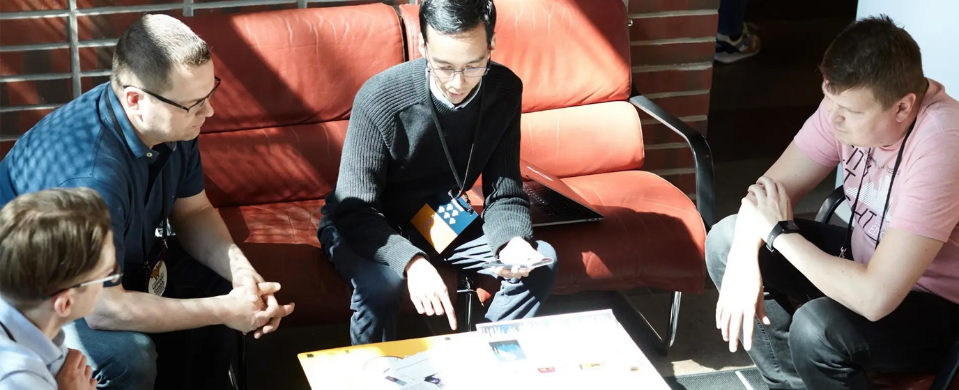 People sitting around table having a meeting.