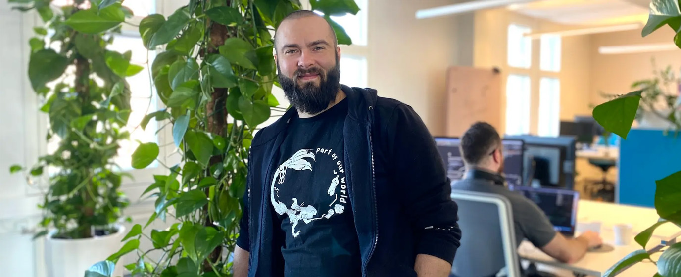 Janne Koponen smiling at Mearra Helsinki office with green plants in the background