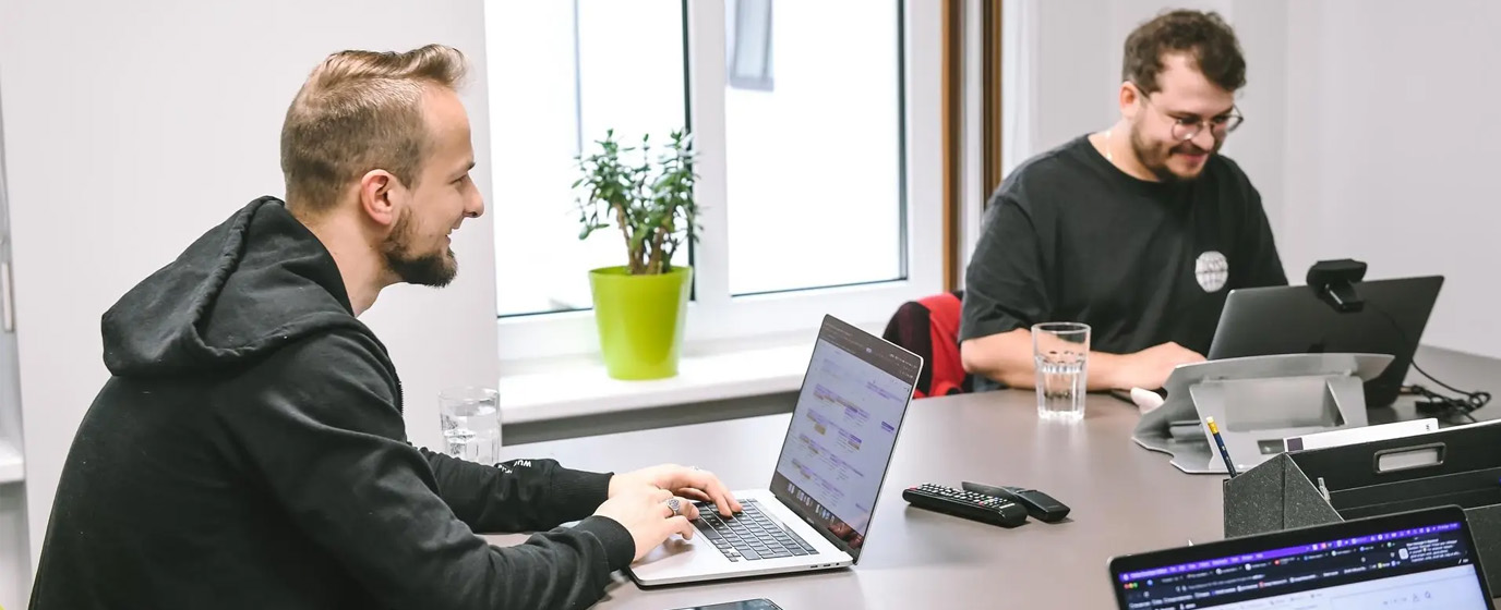 Saimons and Miks working with laptops