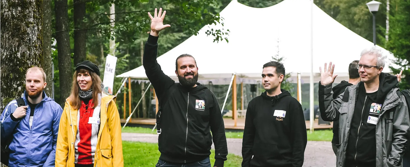 People outdoors dividing into teams and showing five with fingers