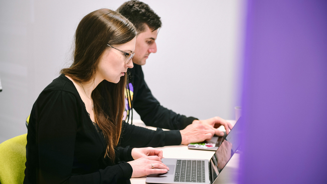 Two people on their computers